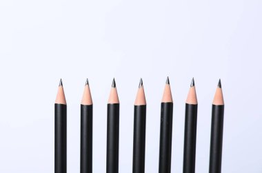 Beyaz arkaplanda birçok keskin grafit kalem, yakın plan