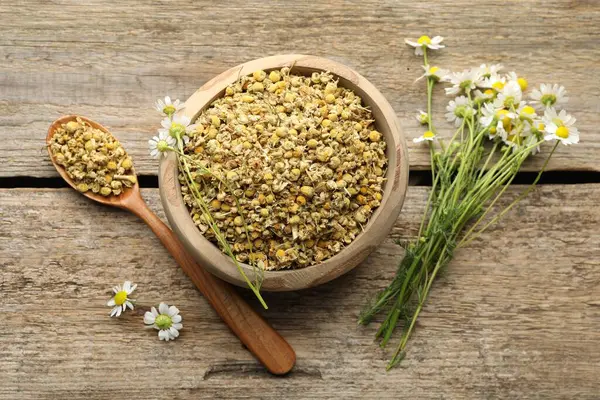 Kuru ve taze papatya çiçekleri ahşap masada, düz yatıyordu.