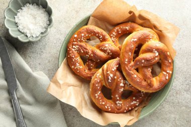 Gri masadaki tuzlu krakerler, düz.