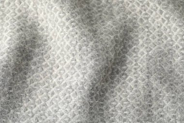 Arkaplan olarak açık gri yün kumaş dokusu, üst görünüm
