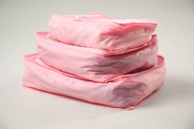 Açık gri arkaplanda giysileri olan küpler paketleniyor