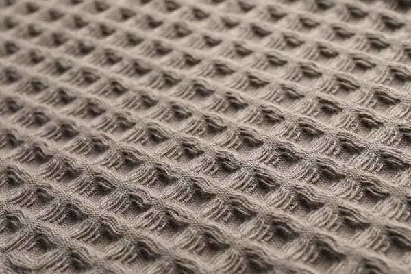 Arka plan olarak temiz kahverengi waffle havlusu, yakın plan