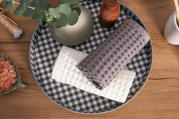 Tahta masanın üzerinde waffle havluları olan düz bir kompozisyon.