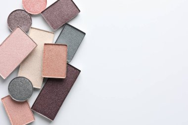 Beautiful eye shadow refill pans on white background, flat lay. Space for text