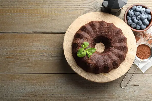 Nane ve böğürtlenli çikolatalı kek, ahşap masa, düz yatak. Metin için boşluk