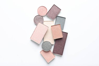Beautiful eye shadow refill pans on white background, flat lay