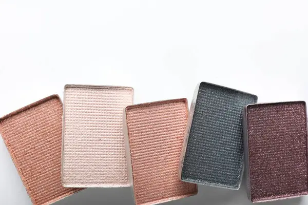 Beautiful eye shadow refill pans on white background, flat lay. Space for text