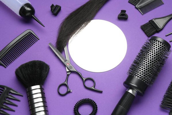Different hairdresser's tools on purple background, above view