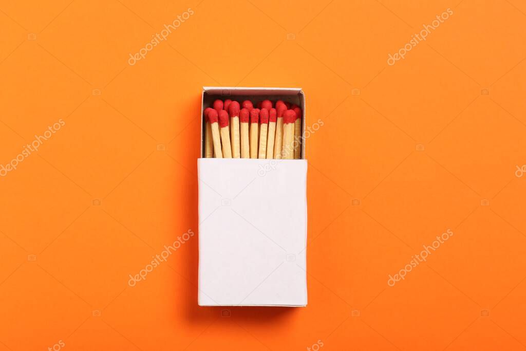 Matches in box on orange background, top view. Mockup for design