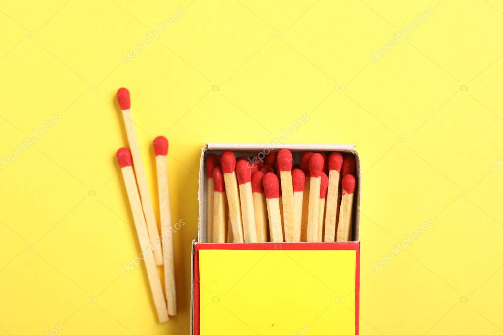 Matches and box on yellow background, flat lay. Mockup for design