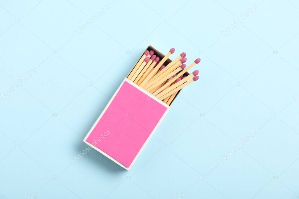 Matches in box on light blue background, top view. Mockup for design