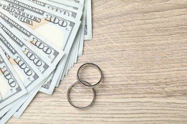 Gümüş alyanslar ve bir dolarlık banknotlar. Metin için boşluk