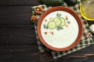 Dereotlu salatalık çorbası, ahşap masada ceviz ve malzemeler, düz yatak. Metin için boşluk