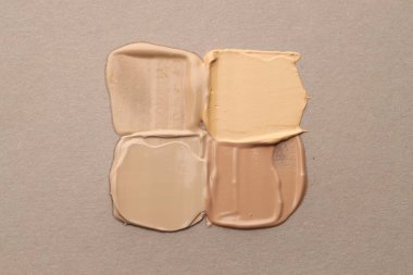 Gri arkaplanda renkli cilt temelleri, düz yatış