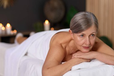 Son sınıf öğrencisi masaj salonundaki kanepede dinleniyor.