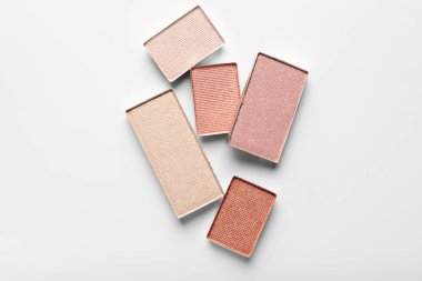 Beautiful eye shadow refill pans on white background, flat lay