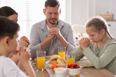 Aile akşam yemeğinden önce evde dua ediyor.
