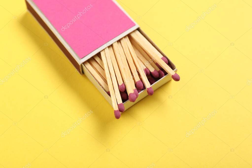 Matches in box on yellow background, above view. Mockup for design