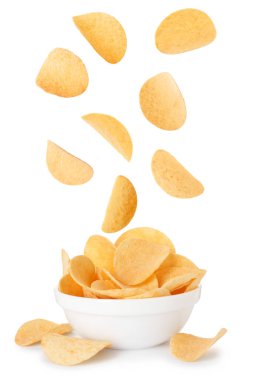 Lezzetli patates cipsleri beyaz arka planda kaseye düşüyor.