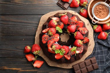 Çilekli, naneli ve çikolatalı nefis kek ahşap masada, düz yerde.