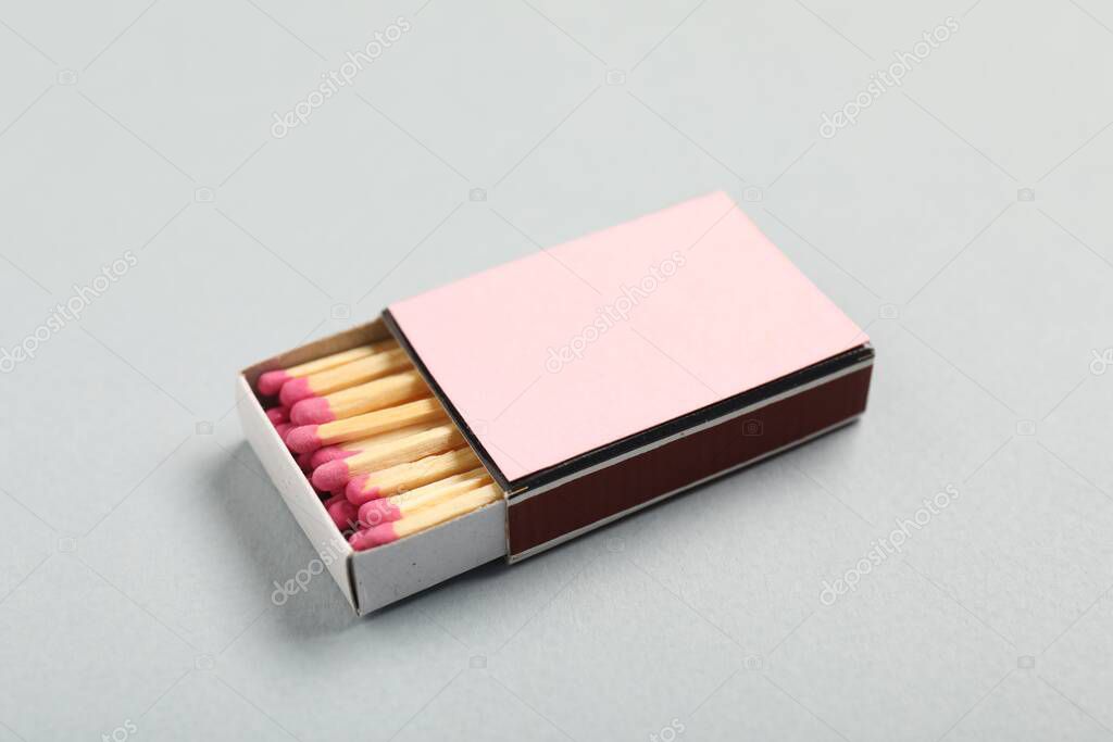 Matches in box on grey background, closeup. Mockup for design