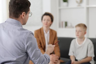 Anne ve oğlu ofiste psikologla görüşüyorlar, seçici odaklanma.