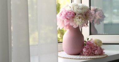 Pencere kenarındaki vazoda güzel şakayıklar