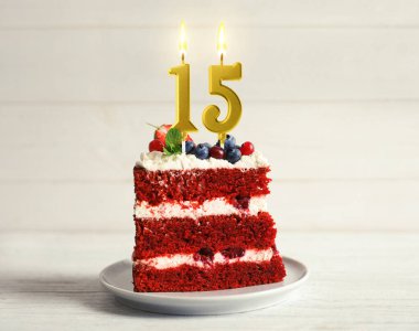 Böğürtlenli kek ve beyaz ahşap masada yanan mumlar. 15. yaş günü veya başka özel bir gün.