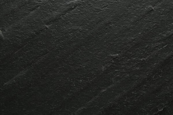 Черная текстурированная поверхность как фон, вид крупным планом