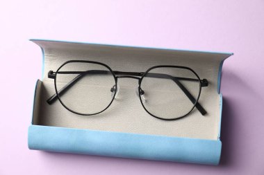 Mor arka planda şık gözlüklü çanta, üst görünüm