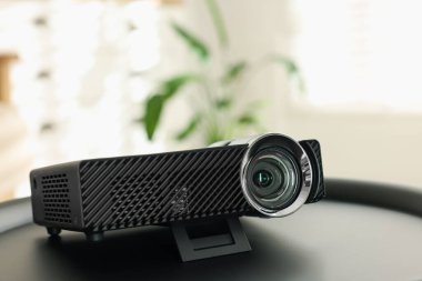 Modern video projektörü siyah masada kapalı, yakın plan
