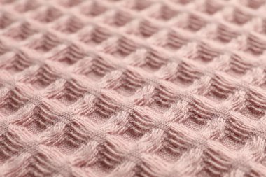 Arka plan olarak temiz pembe waffle havlusu, yakın plan