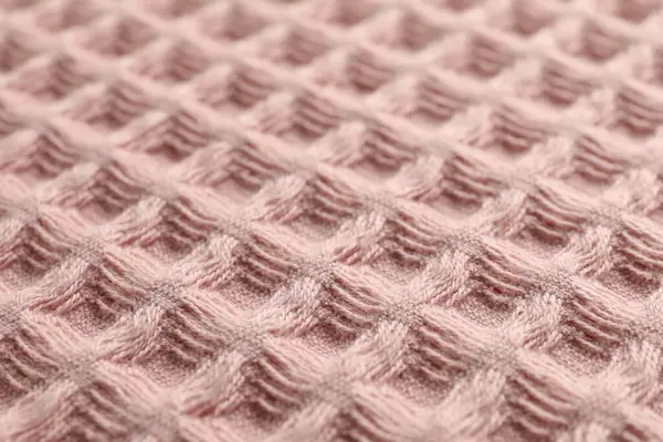 Arka plan olarak temiz pembe waffle havlusu, yakın plan