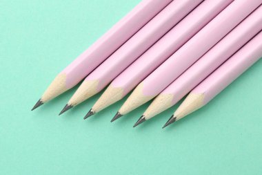 Turkuaz zemin üzerinde birçok grafit kalem, düz yatıyordu