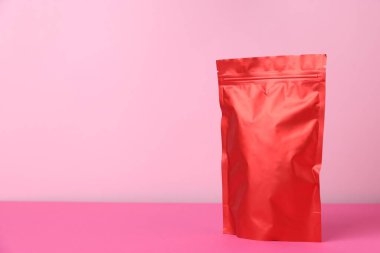 Pembe arka planda fermuarlı bir stand-up kesesi. Tasarım için model