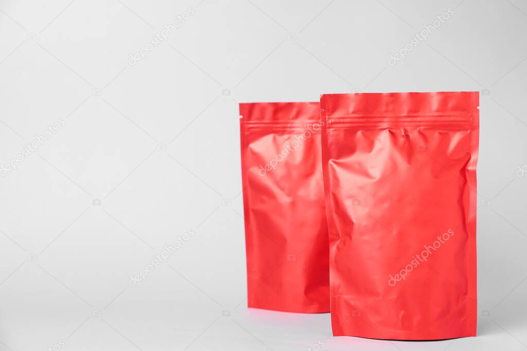 Zipper stand-up pouches on light grey background. Mockup for design