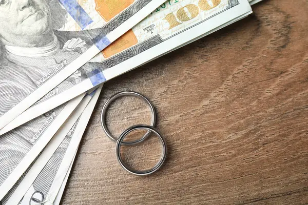 Gümüş alyanslar ve bir dolarlık banknotlar. Metin için boşluk