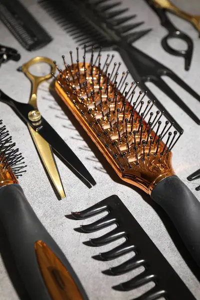 Gri masadaki farklı kuaför aletleri, yakın plan.