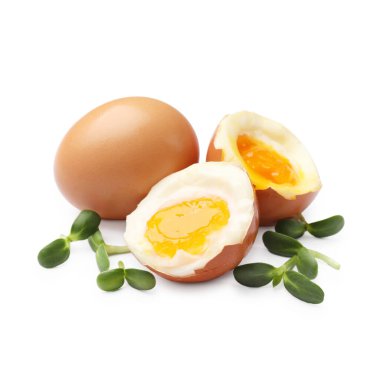 Beyaz zemin üzerinde mikro yeşillikler olan yumuşak haşlanmış yumurtalar.