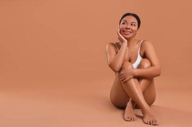 Bej arkaplan üzerindeki epilasyon işleminden sonra pürüzsüz ciltli kadın, metin için boşluk