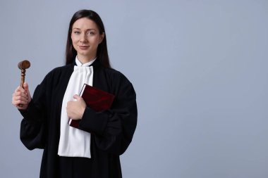 Gri arkaplan üzerine kitap ve çekiçle yargıla, metin için boşluk