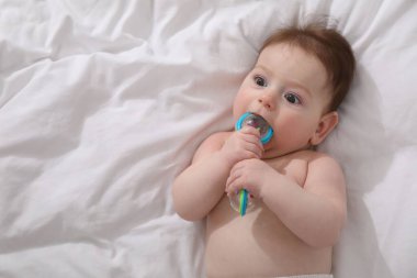 Evdeki yatağında çıngıraklı oyuncağı olan sevimli bir bebek. Metin için boşluk