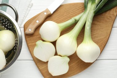 Taze taze soğan, tahta ve bıçak ile beyaz ahşap masa, düz yatıyordu.