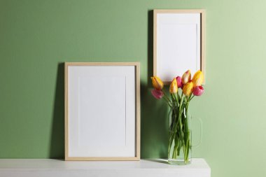 Boş resim çerçeveleri ve güzel laleler.