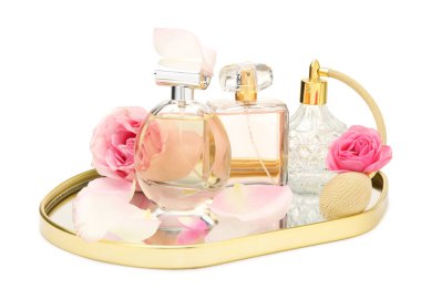 Birçok farklı parfüm şişeleri ve güller beyaz üzerine izole edilmiş.