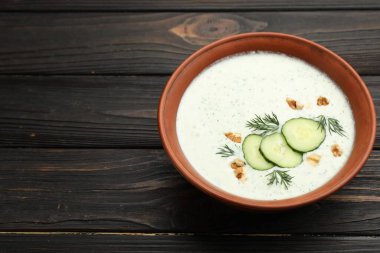 Ahşap masada dereotlu ve cevizli lezzetli salatalık çorbası, yakın plan. Metin için boşluk