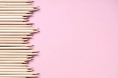 Pembe arka planda birçok grafit kalem var. Metin için boşluk