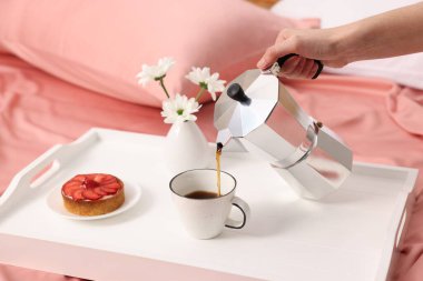 Kadın yatakta nefis bir kahvaltı yapıyor, yakın plan.