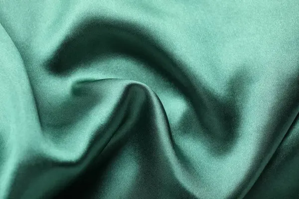 Arkaplan olarak buruşmuş yeşil ipek kumaş, üst görünüm