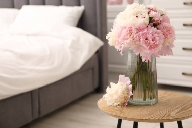 İçerideki ahşap masada vazodaki güzel şakayıklar. Metin için boşluk